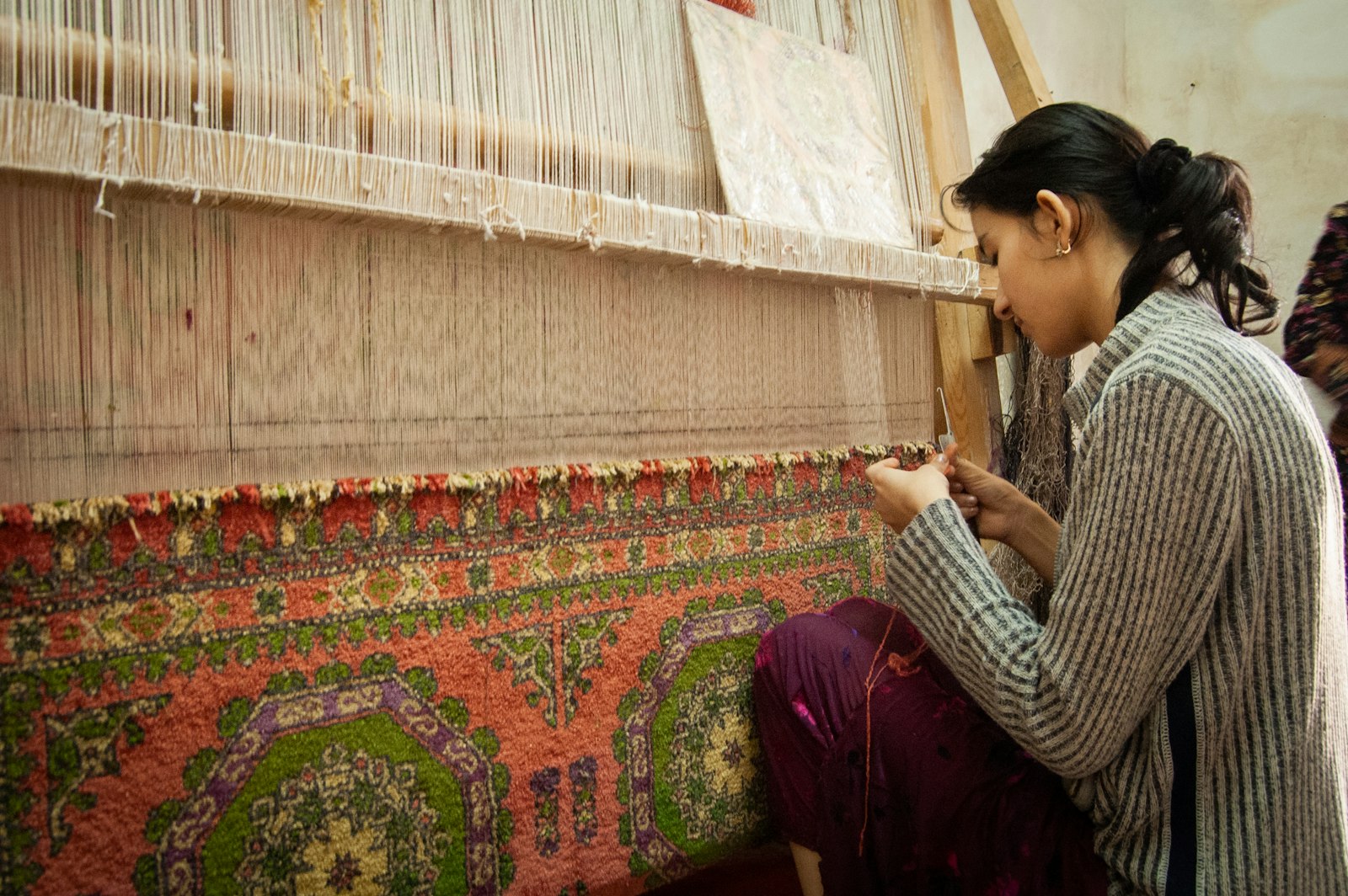 Woman weaving a kilim at a traditional loom