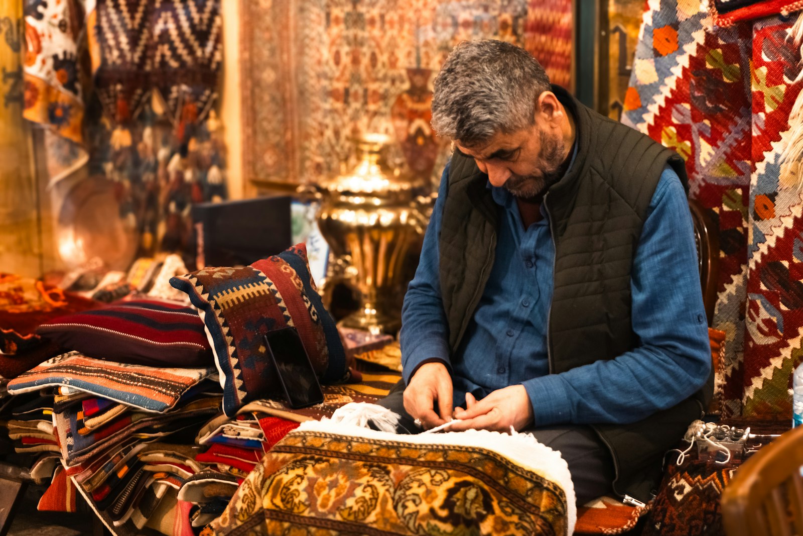 Carpet weaver hand-knotting a rug at the loom
